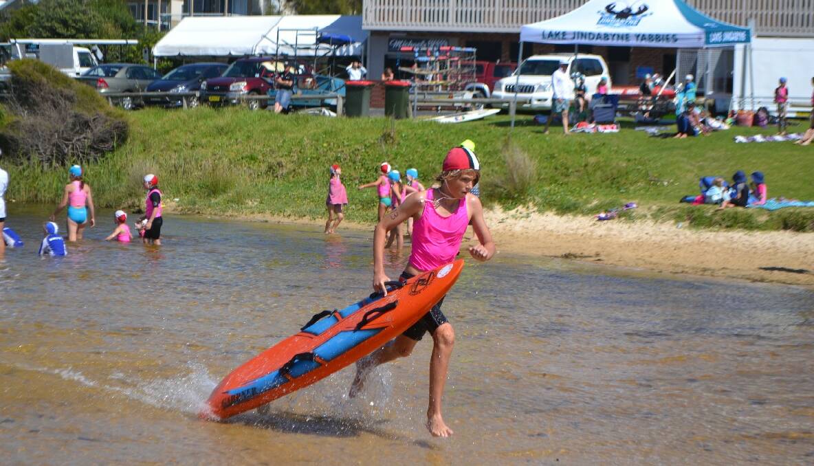PADDLE RUN: Riley Miles powering to the finish line in the under 13 board race held on Little Lake.