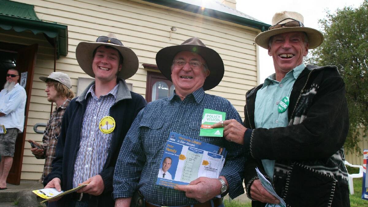 In good spirits and camaraderie while drumming up  votes in Cobargo, from left James Hayes representing the Palmer United Party, Bill Boyle supporting the Liberal Party and Rowan Dixon for the Greens.