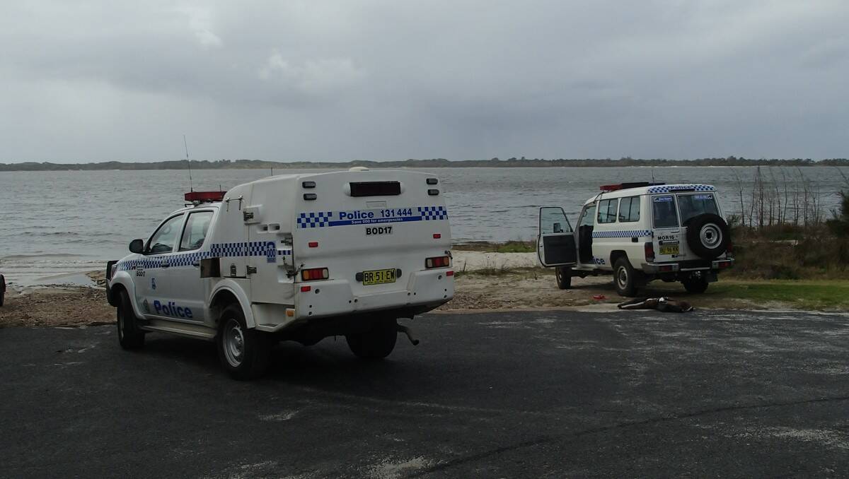 Police at the scene of today's tragic death at Coila Lake on the South Coast.