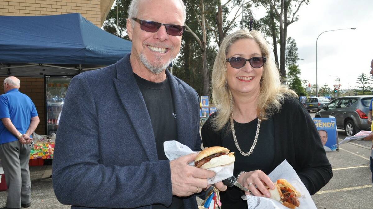 Matthew and Candy Burgess enjoy a steak sandwich and sausage sizzle at Batemans Bay High School. 