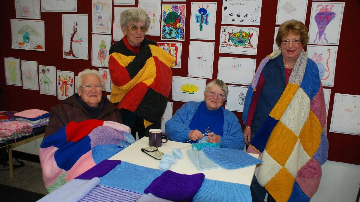  COOMA: At the Cooma Library everyone pitched in to stitch up the many Wrap with Love rugs that will soon make their way to the   homeless in Australia and across the world. Pictured are Margaret Kellond, June Kennedy, Ruth Dahl and Better Mattner. 