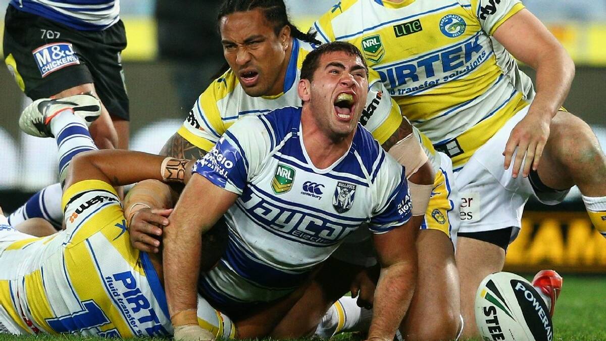BEGA: Bega’s Dale Finucane celebrates his first try in the NRL recently for Canterbury. Finucane has re-signed with the   Dogs until the end of 2016. Photo: Getty Images
