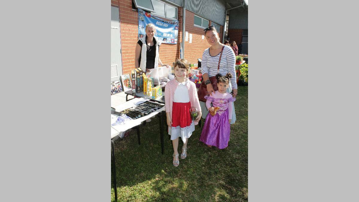 Bega High School teacher Sharon George sells items to (from left) Luchia, Matilda and Maddalyn Fox at the school's stall.