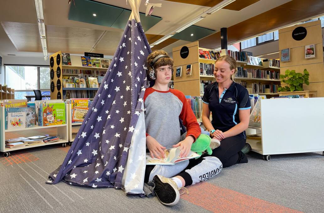 Occupational therapist Gabbie Johnson introduces Leo Degraaf to the sensory activity area at Moruya Library. Picture by Eurobodalla Shire Council.