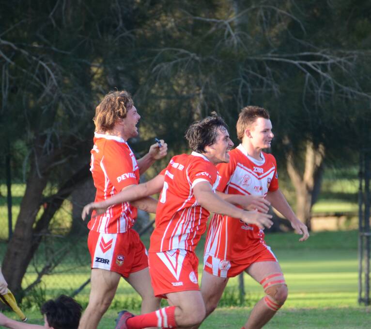 The Narooma Devils celebrate shortly after their game-winning try at Ack Weyman Oval in Moruya.