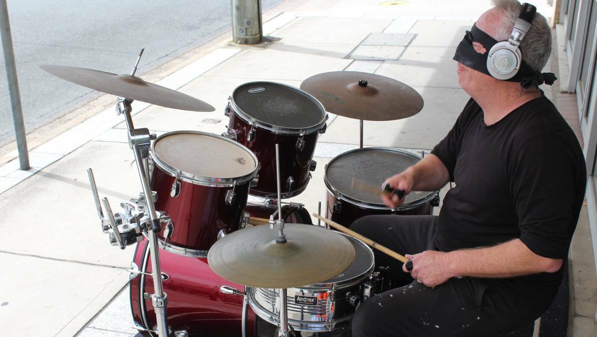 Richard Lawson plays the drums outside Andrew Constance's office as the Lone Drummer in 2018.