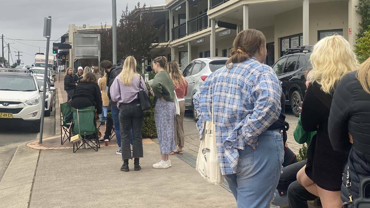 The line of people outside Blanc Space Studio in Milton, NSW during Em Reid's flash event in May 2022. People from Goulburn, Sydney and Wollongong travelled down for a tattoo at her studio. Picture: Grace Crivellaro