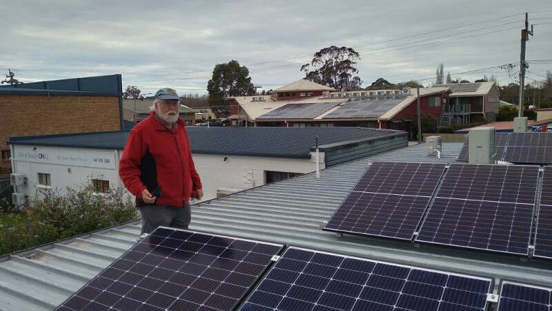Project Manager Thomas Schild with the rooftop solar panels. Picture supplied.