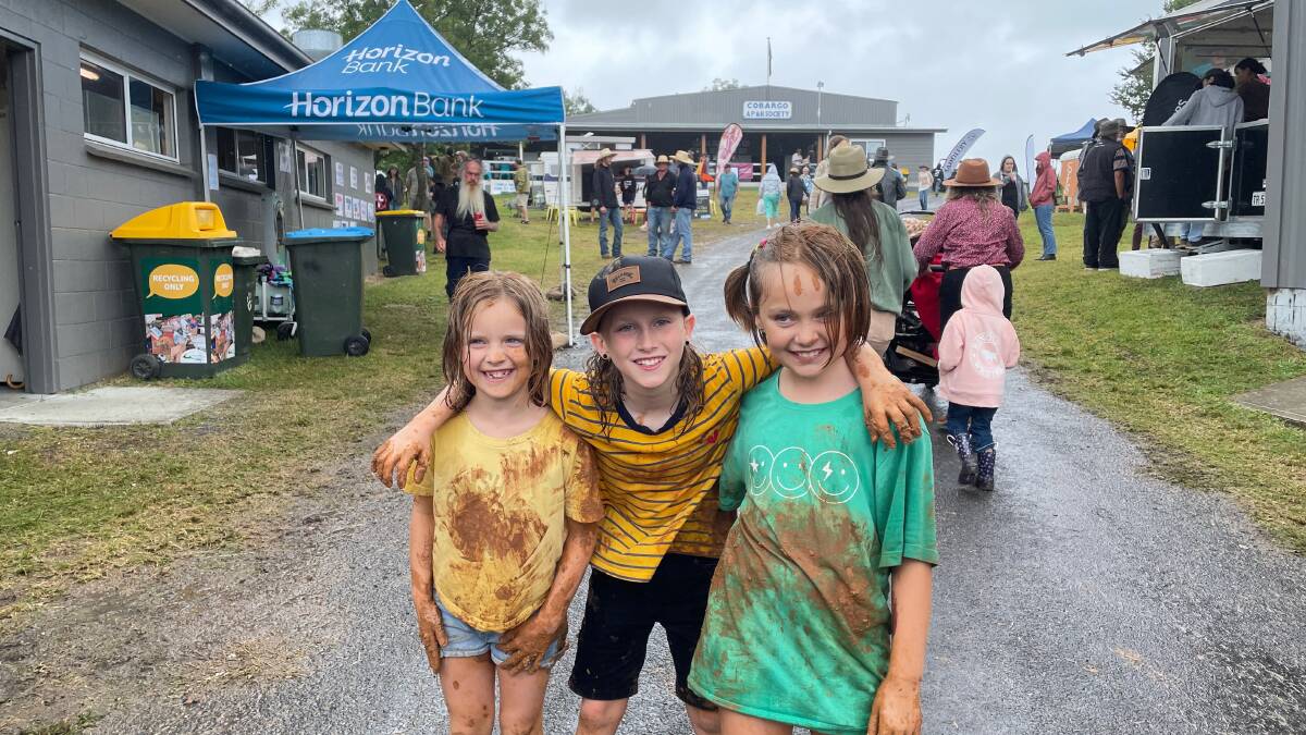 The rain and mud did not get in the way of Zoe, Lily and Franklin having the time of their lives at the 125th Cobargo Show on Saturday, February 10. Picture by Marion Williams