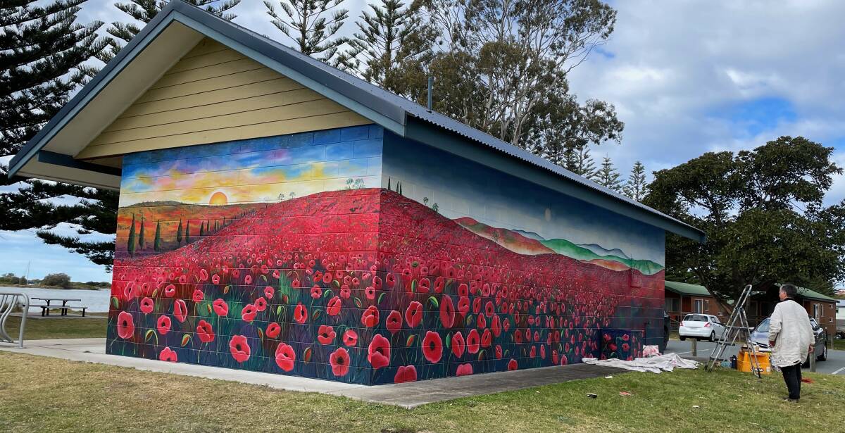 People driving into Narooma from the north will be greeted by this colourful and evocative mural. It took Samantha Wortelhock five days to transform the toilet block at the Avenue of Remembrance. Picture by Marion Williams