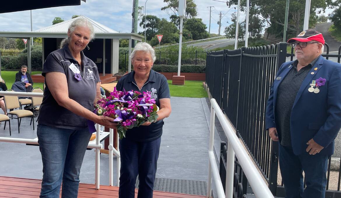 Members of the Eurobodalla branch of the Animal Welfare League laid a wreath at the War Animal Day service at Club Narooma on Saturday, February 24, watched on by Narooma RSL sub-Branch member David Kelleher. Picture by Marion Williams