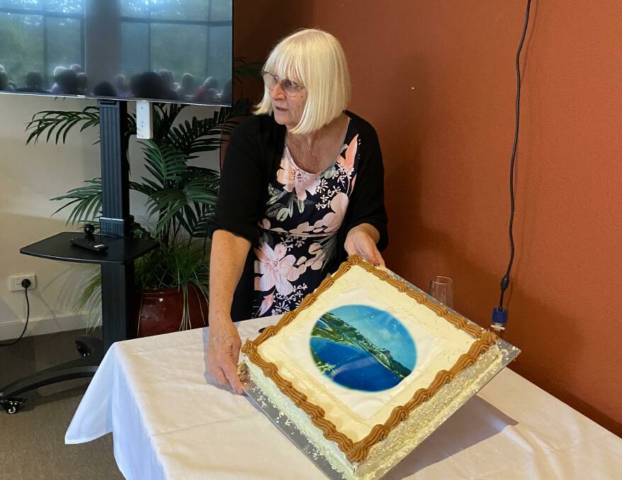 Sylvia Gauslaa with the cake that is decorated like the front page of her book. Picture supplied