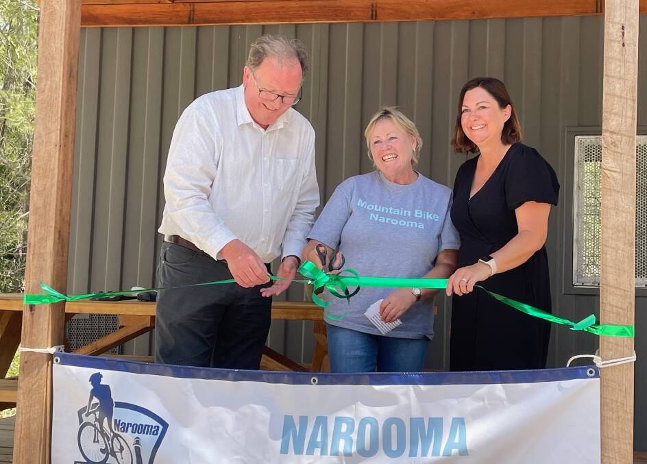 Member for Bega Dr Michael Holland, Georgie Staley co-founder of Narooma Mountain Bike Club and member for Eden-Monaro Kristy McBain cutting the ribbon at the official opening of the Narooma Mountain Bike Trails Hub on Friday, February 2. Picture by Marion Williams