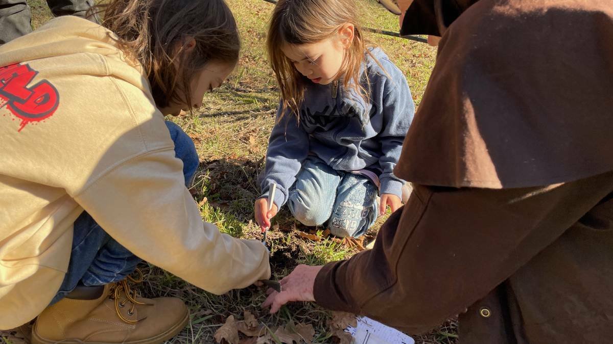 Ethan and Fallon loved sniffing out the truffles and gently getting them out of the ground using a spoon at the Gulaga Gold truffle hunt on Saturday, June 17. Picture by Marion Williams.
