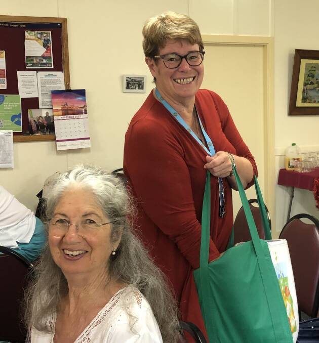 Stephanie Stanhope, president Far South Coast Group CWA, handing out Christmas chocolates to CWA members at a recent meeting in Cobargo. A very pleased Susanne Robertson of Tilba CWA in foreground. Picture supplied
