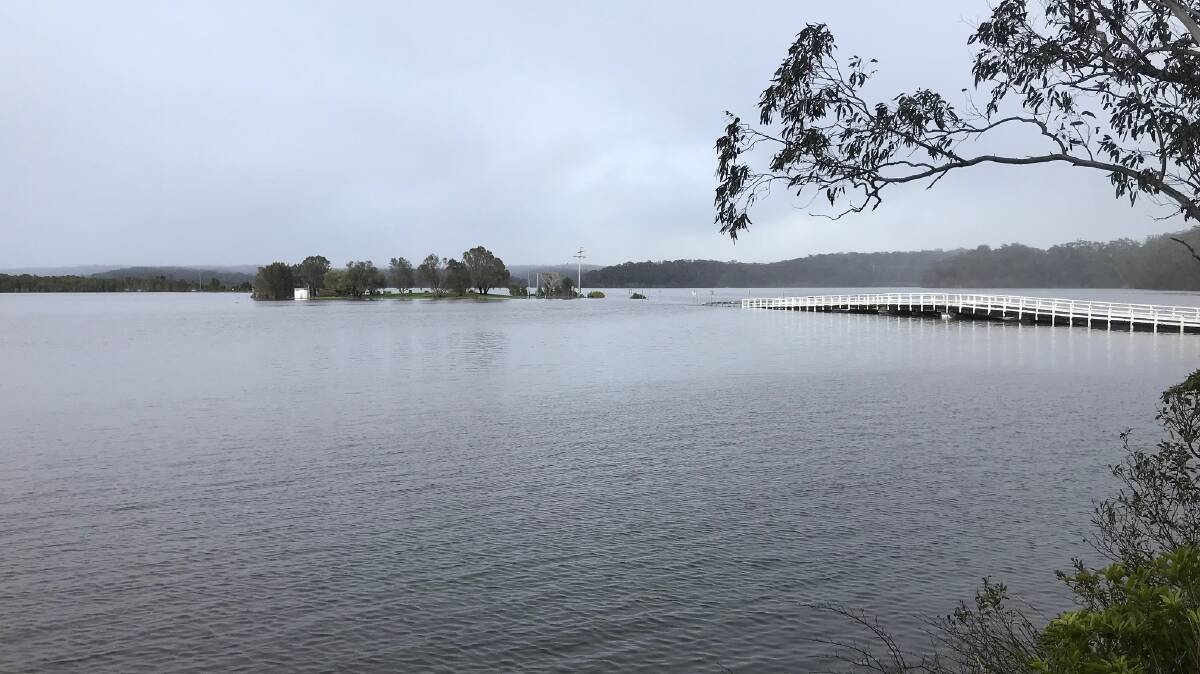 The causeway on the southern side of Wallaga Lake Bridge flooded on November 30, 2023, after heavy rain earlier in the week. Picture by Martin Oswin