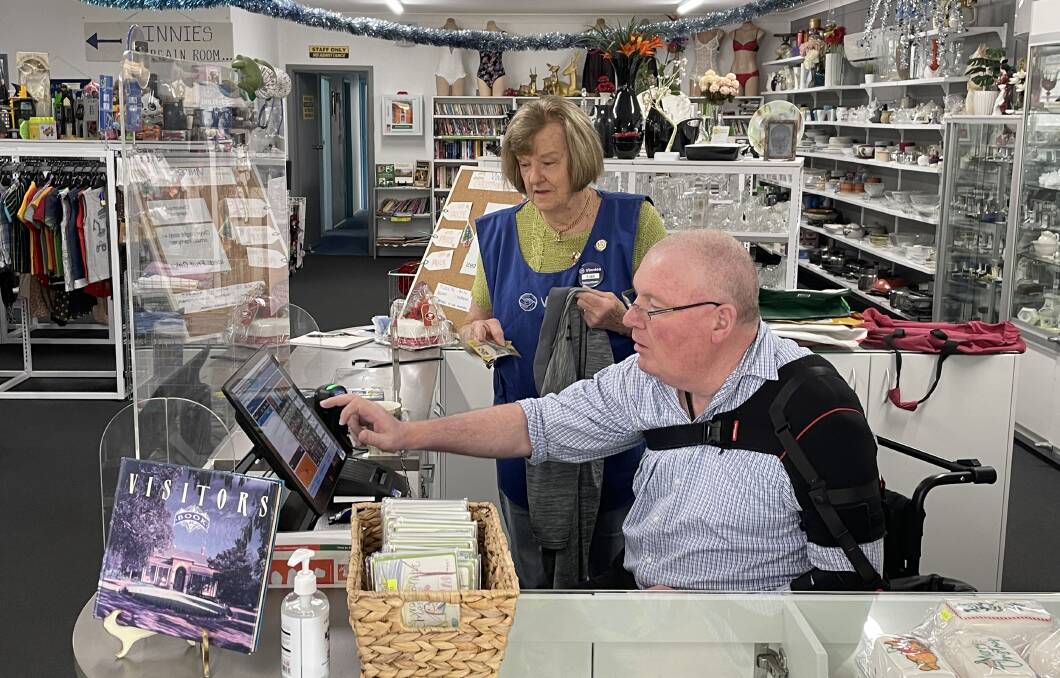Simon is able to work the front desk with help from other staff at Vinnies. Picture by Sam Armes.