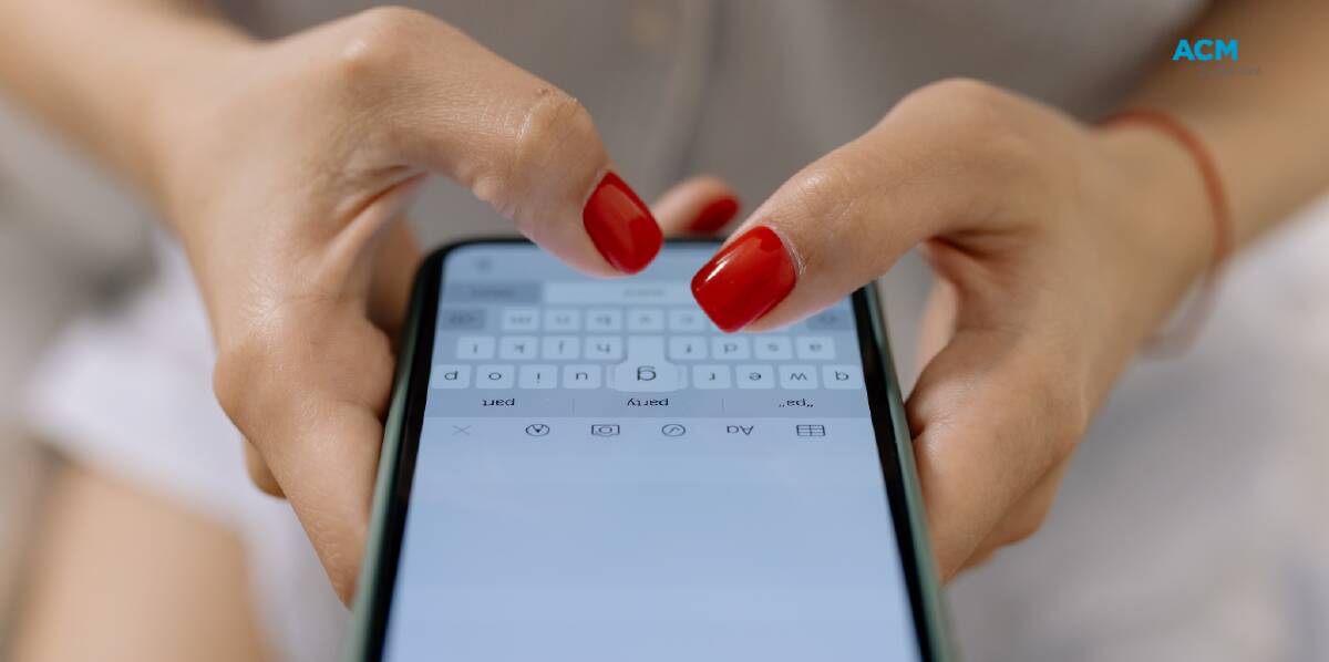 Stock image of a woman writing a message on her phone. Picture Canva