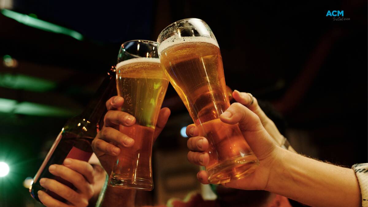 Friends toast their beers. File picture