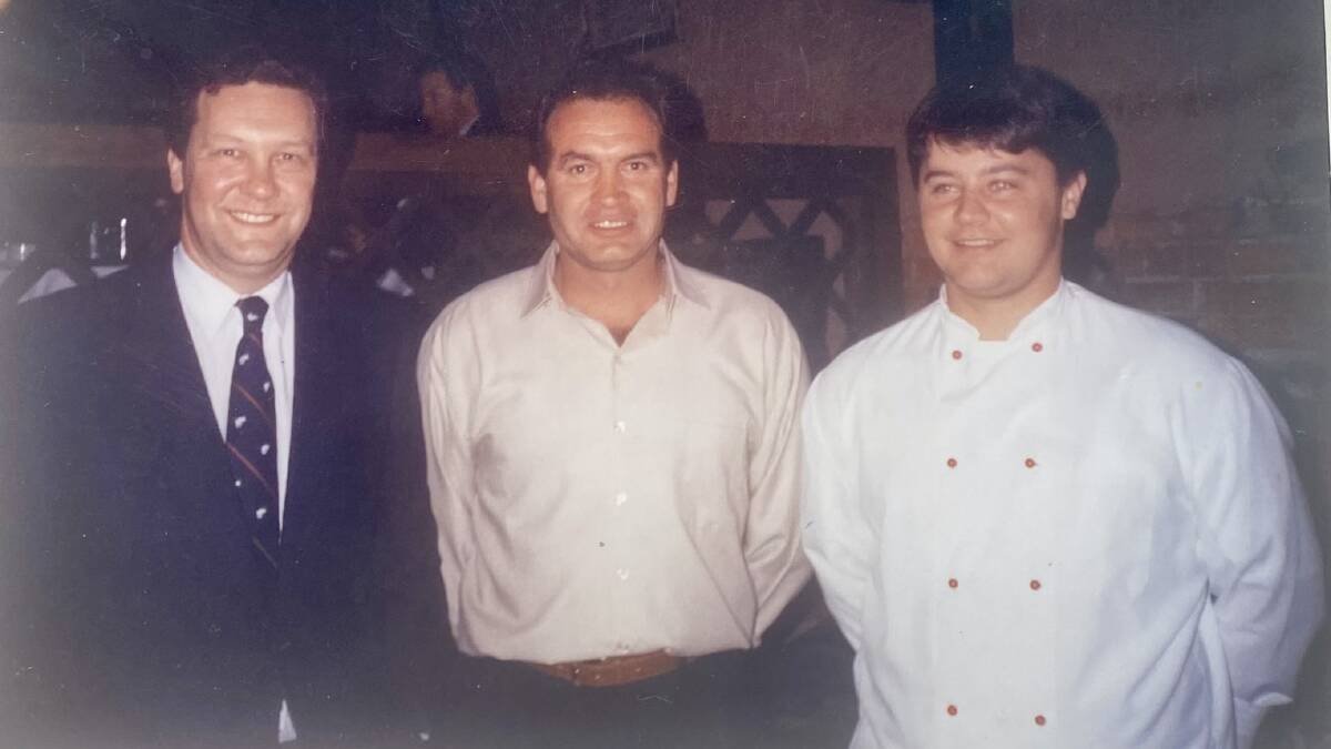 John Smith (centre) with key political figure Alexander Downer and the head chef while managing The Butter Factory Restaurant in the 1990s. Picture supplied.