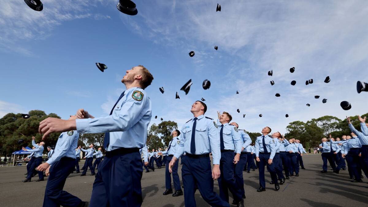 Hats fly as the probationary constables celebrate graduating from the NSW Police Academy at Goulburn. Picture supplied.