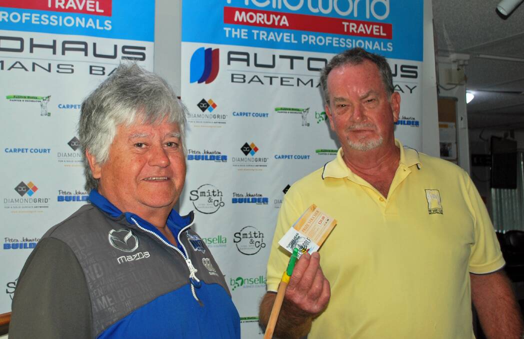 Tuross Head Country Club golf president Andrew Gordon presents the winner's voucher to Steve Collins.