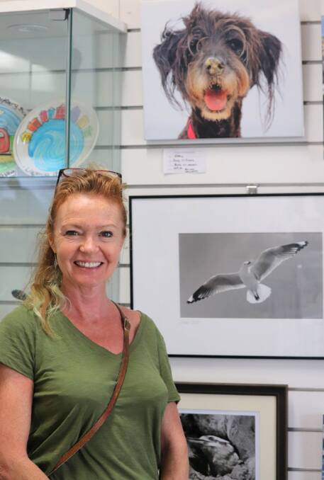 Performer, singer Tracy Hardwick from Katoomba admires the gallery at the Narooma Visitor Information Centre while on holidays here.