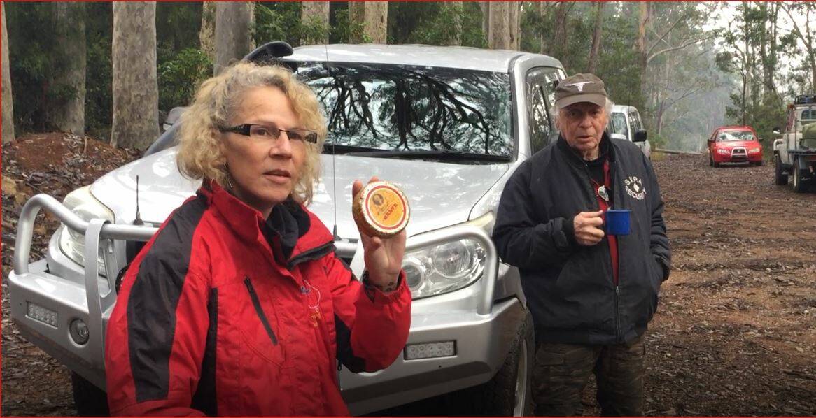 WHAT THEY'RE LOOKING FOR: Ray Speechley's daughter Nikii Smith shows volunteers a distinctive tin of antiseptic like the one her father was carrying on the day he disappeared.