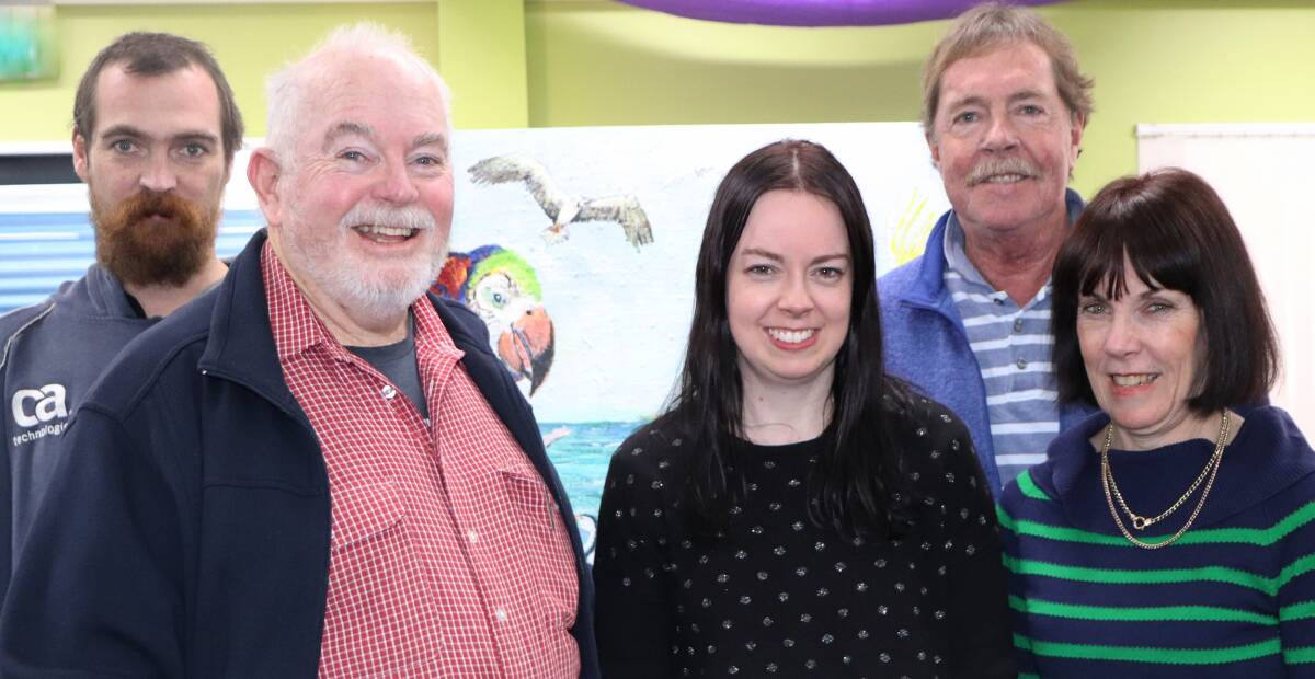 MACS MOMENT: MACS artist Gary Caldow, centre, did the society proud at Narooma Library last week. His son Phillip and niece Kylie O'Brien were there to hear his entertaining floor talk.