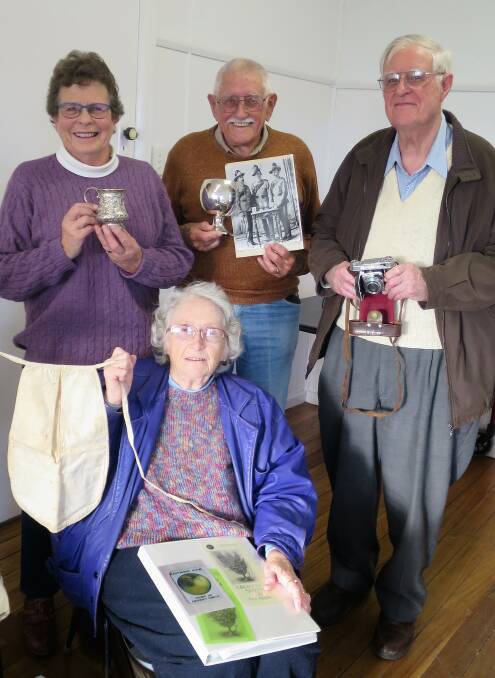SPECIAL EFFECTS: Narooma Historical Society members Jen Mathieson, Jim Harrold, Paul Goard and Marion Goard show off special possessions at the June meeting.