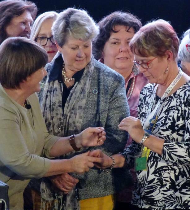 BADGE OF HONOUR: CWA State President Annette Turner gives Sally James her State CWA Vice-President badge last year.