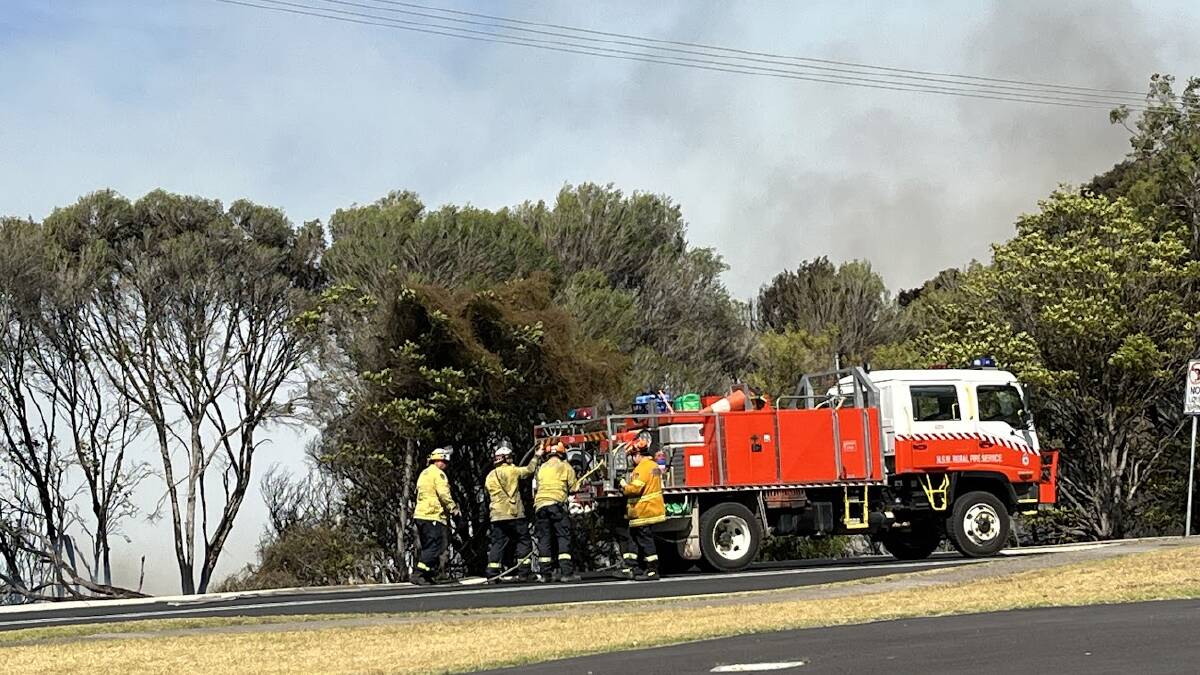 Flames and smoke plume over Eden after a grass fire broke out in the vicinity of Aslings Beach. Picture by James Parker