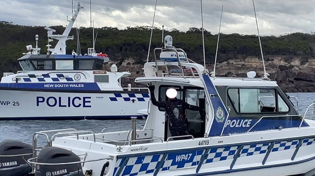 One lucky man, the spearfisherman gives the okay signal while being transported to Eden by Water Police after being located uninjured. Picture supplied