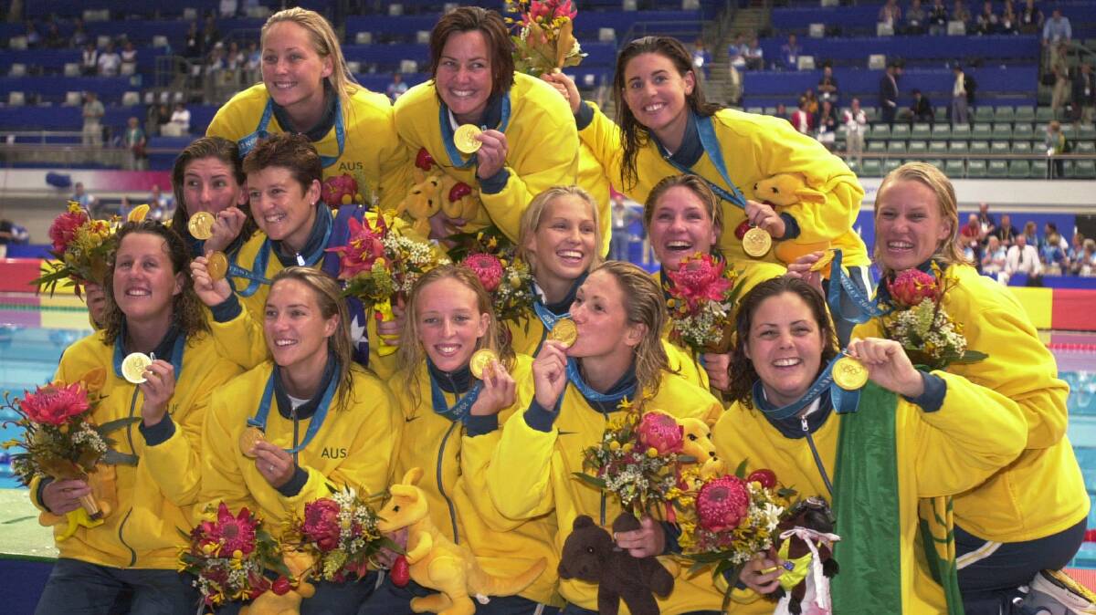 Australian water polo players after winning the first-ever women's Olympic gold medal in the sport at the Sydney 2000 Olympics. Photo: AAP/Julian Smith
