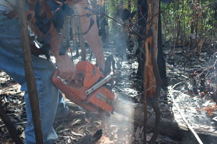 A South Coast resident cleans up his property after the recent bushfires. 