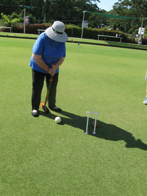 Mary Ryan sets up the white ball at hoop 7 in game 3 of golf croquet.