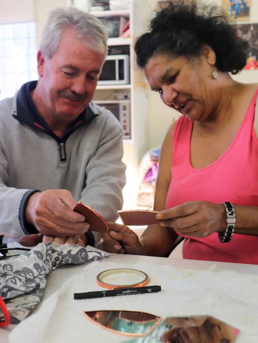 CRAFT: Tutor Bob Burnside and Sharyn Close work together at the MACS Studios to produce some glass foiling for mirrors and special lead lighting pieces to take home.