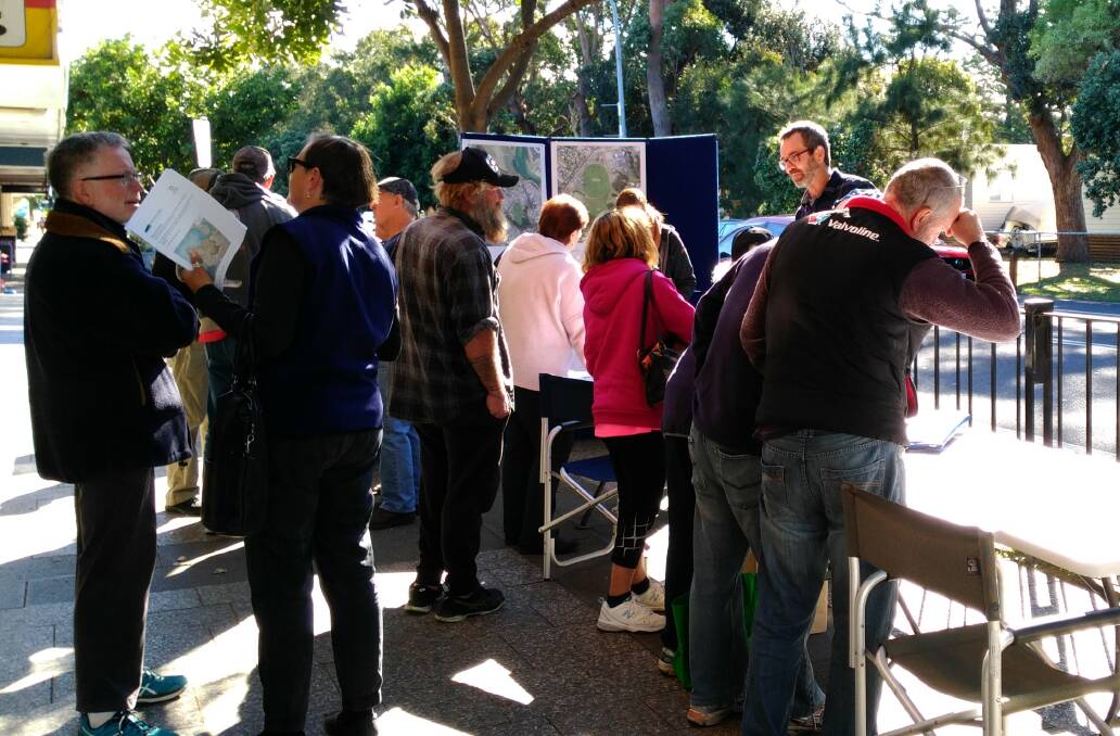 People asking questions and giving feedback on the future plans of Narooma Flat. 