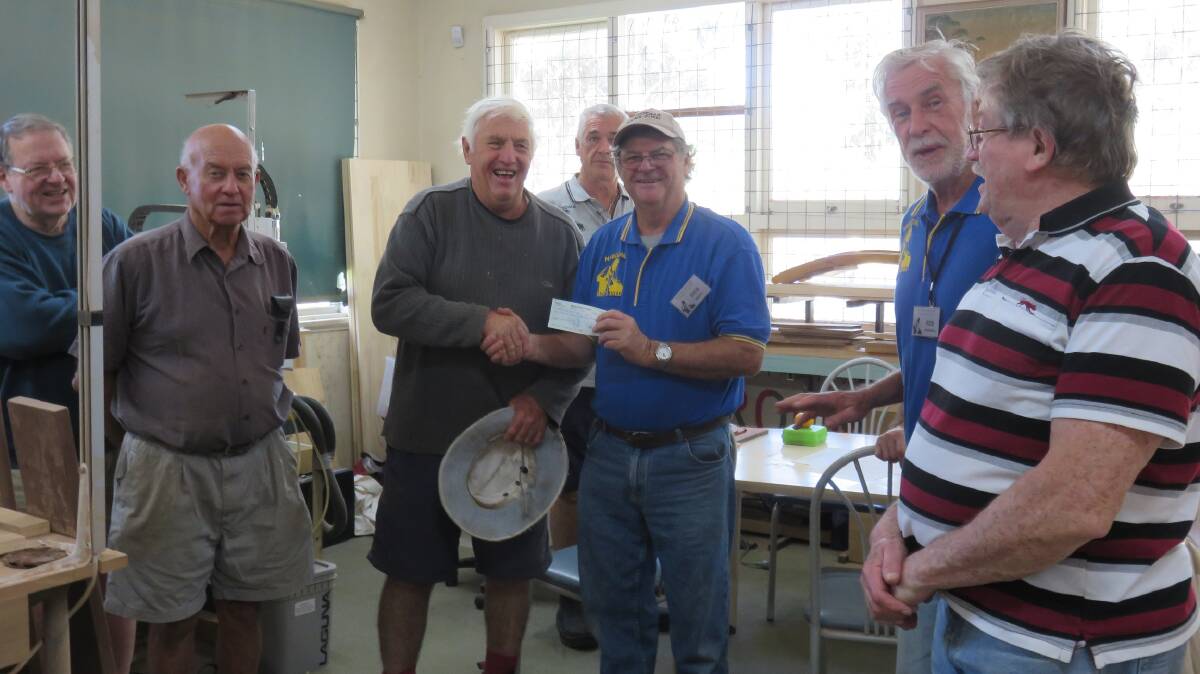 The Narooma Men's Shed accept a lovely donation from the Narooma Woodies.