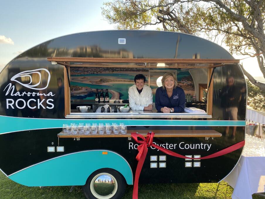 Keep an eye out for the Narooma Rocks van this summer - it will pop-up at Bar Beach and other spots around town as the Narooma Oyster Festival committee shares some early festival vibes. Pictured are Business Council Chief Executive Jennifer Westacott with festival chair Cath Peachey at the launch of the oyster van in April 2021.