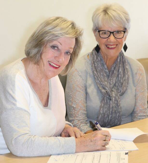 MACS president Judy Glover signs the new lease with Margi O'Connor.