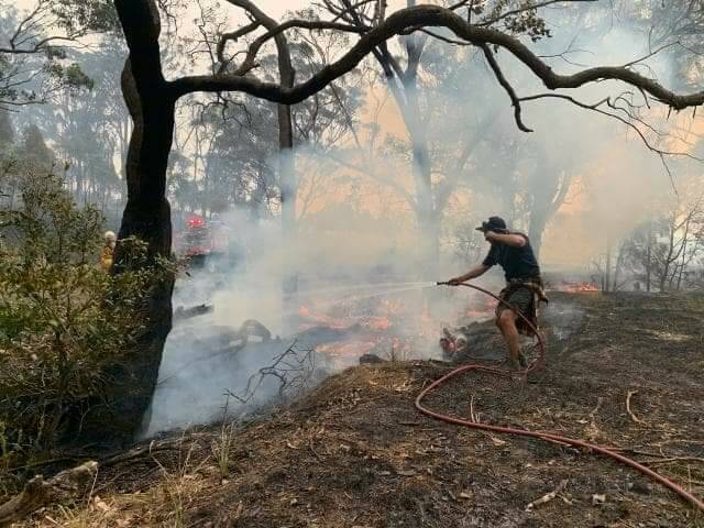 Steve bounces between working at Southlands and helping put out a spot fire in a paddock two houses away from his and Katie's home at Meringo on January 23. 