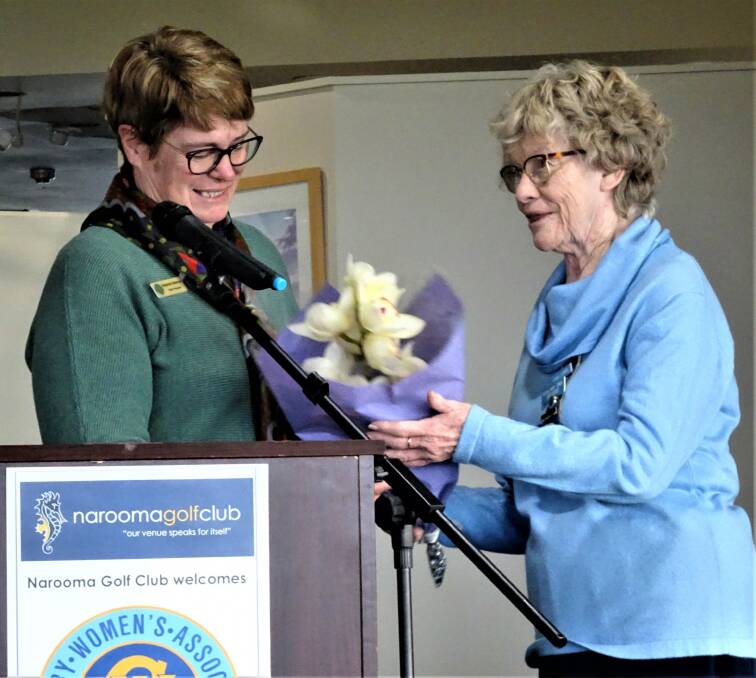 Narooma CWA President Louise Starkie presenting orchid to guest speaker CWA of NSW President Stephanie Stanhope.