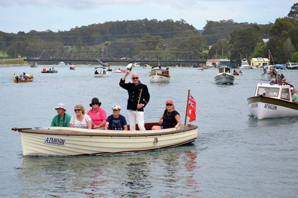 The grand parade of the Boats Afloat Festival attracts a huge crowd at the Narooma Bridge and boardwalk. 