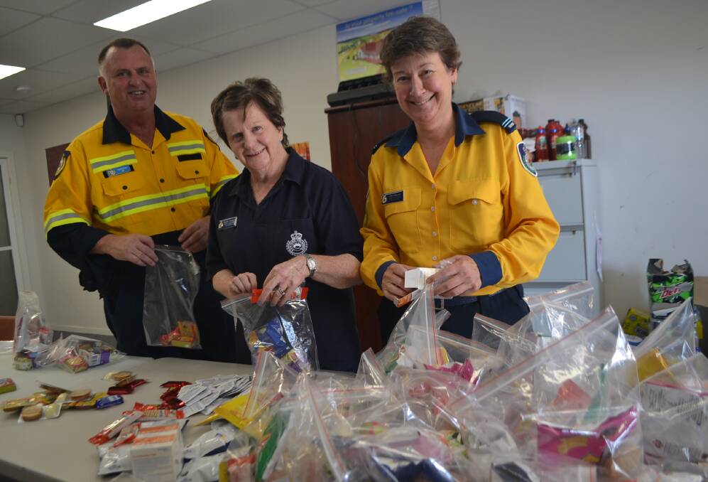 Staff of the Department of Justice NSW Sheriff Office helps the Eurobodalla RFS Catering Brigade. They prepare more than 400 snack packs each day at the Moruya Control Centre. 