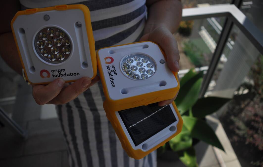 Moruya's Mary Dullard shows Origin Energy sponsored solar lights. 