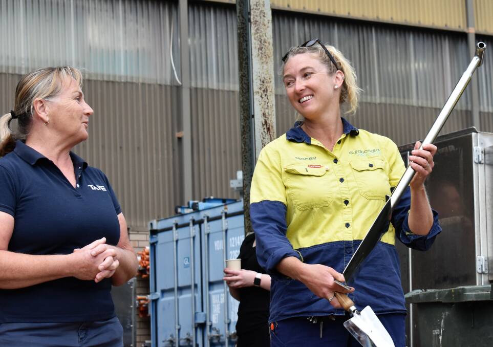Moruya TAFE's Gabriele Harding presents Council's parks and gardens apprentice Stacey Wade with The Shovel.