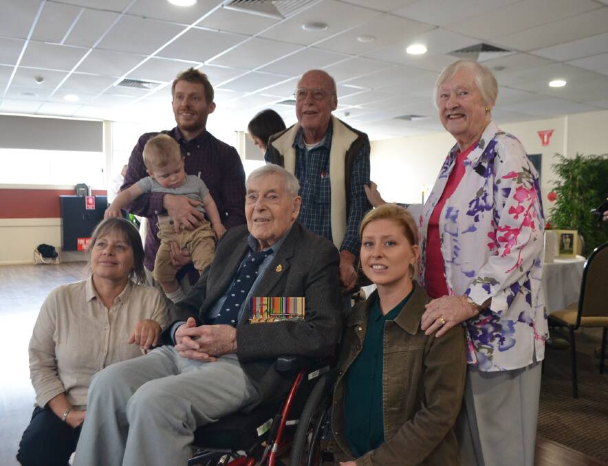 Three generations: Allan Forster (centre) with his family celebrating his 100th birthday at Club Narooma on Friday.