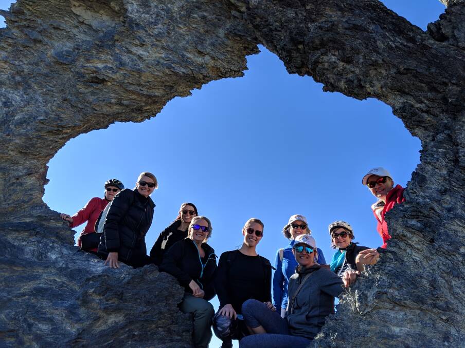 Eurobodalla Shire Council tourism staff stop in to check out Narooma's Australia Rock during an e-bike tour. 
