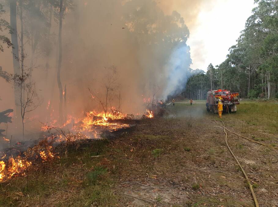 Fire crews work to extinguish a bush fire at Potato Point on Saturday, May 25. Picture: Tuross Head Rural Fire Brigade Facebook.